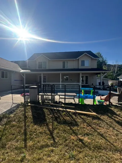 Before and after exterior home repaint with new blue paint and trim in Roseburg, OR